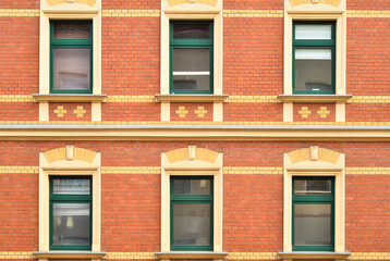 View of brick building with wooden windows