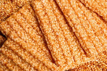 Tasty sesame kozinaki as background, closeup