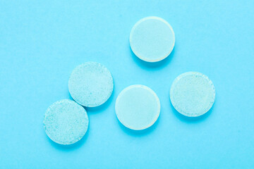 Soluble tablets on blue background