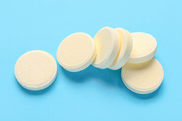 Yellow soluble tablets on blue background