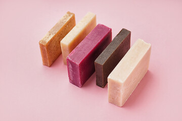 Set of natural soap bars on pink background