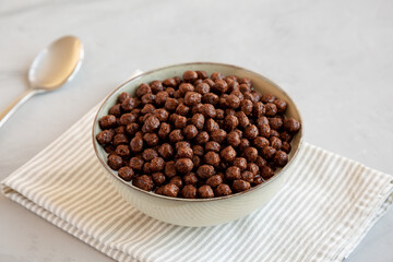Chocolate Puff Cereal with Milk in a Bowl, side view.
