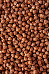 Chocolate Puff Cereal with Milk in a Bowl, top view. From above, overhead, flat lay.