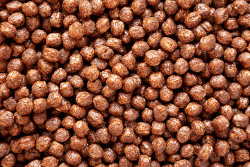 Chocolate Puff Cereal with Milk in a Bowl, top view. From above, overhead, flat lay.