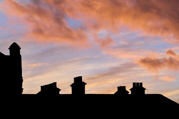 Fototapeta premium Roof of a building in a shadow during scenic pink sunset