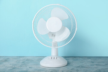 Electric fan on blue background