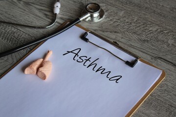 Stethoscope, human lung model and paper clipboard with text Asthma. Medical and healthcare concept