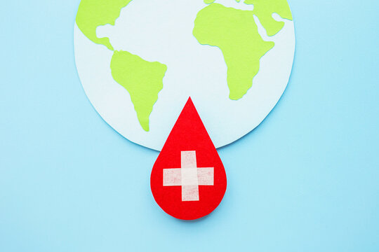 world hemophilia day. world globe with blood drop paper cut, blood transfusion