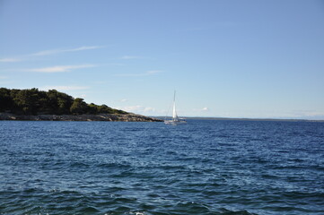 Sailboat in the rough sea with horizon line in background. Island Losinj touristic and yacht destination on Adriatic Sea.