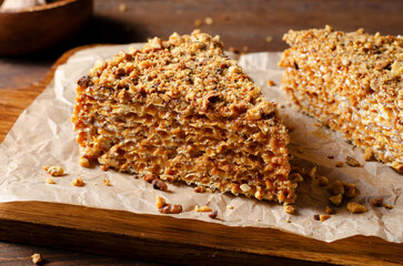 Wafer Cake with Condensed Milk and Nuts, Layered Cake on Wooden Background