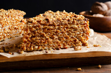 Wafer Cake with Condensed Milk and Nuts, Layered Cake on Wooden Background