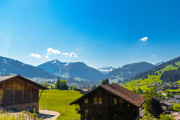 Fototapeta premium Houses and green meadows, Gruyere, Fribourg Switzerland