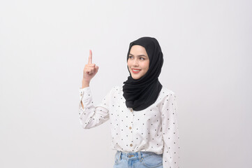 Portrait of beautiful muslim woman with hijab over white background studio.