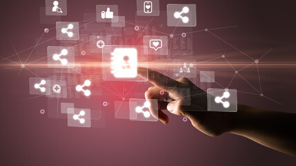Hand pressing social media multimedia application screen with media icons on futuristic concept