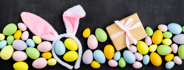 Stylish background with colorful easter eggs on dark concrete background