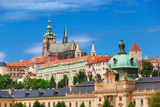 View of Prague old historical center with gothic St. Vitus Cathedral and Straka Academy baroque dome