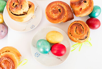  Colorful Easter eggs and sweet buns tied with a ribbon.Photo from above.