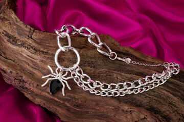 spider necklace isolated on  silky background.