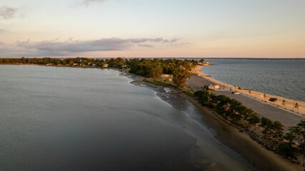 Aerial view of a golden sunrise on the gold coast of Long Island, New York, over an empty beach.