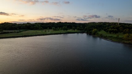Aerial view of a golden sunrise on the gold coast of Long Island, New York, over an empty beach.