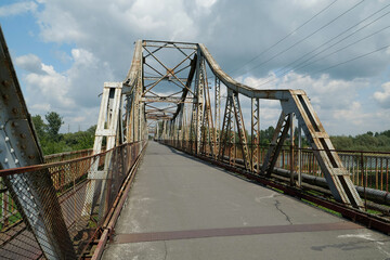 Fototapeta na wymiar Old metal bridge across Dniester river in the city of Halych, western Ukraine