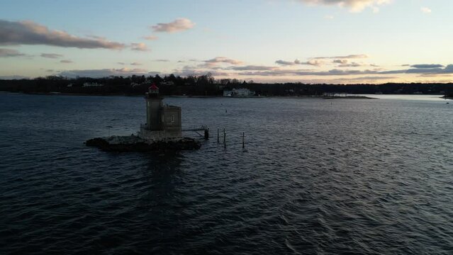 Drone view over a lighthouse in Huntington Harbor on Long Island in New York during a sunset