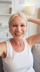 Happy selfie. Positive emotion. Carefree lifestyle. Portrait of amused cheerful smiling senior woman taking picture at home interior.