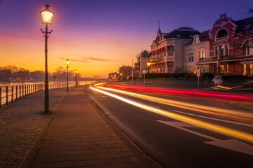 Long exposure of a busy street alongside a coast during sunset
