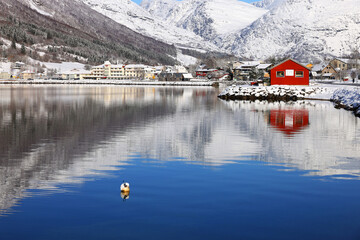 Fototapeta premium View of the village of Skei and lake Jolstravatnet, in Sunnfjord Municipality, Vestland county, Norway. Scenic landscape in winter, with reflections on the water. 