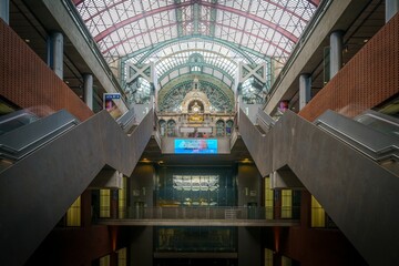 Low angle shot of the interior of the Antwerpen-Centraal railway station, with the stairways visible