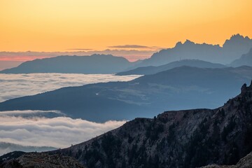 Silhouette of mountains covered by fog during the sunset in South Tyrol