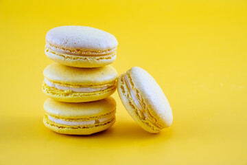 close up of four Yellow Macaroon party biscuits isolated on a yellow background