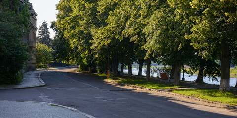 river in the town at sunrise. longest linden alley in europe. popular travel destination