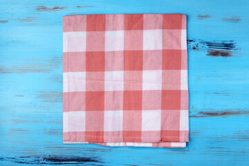 Empty red kitchen napkin on a blue wooden background