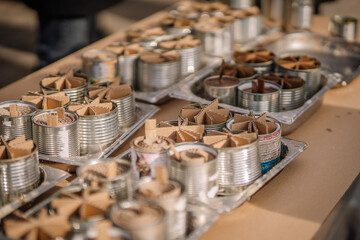 Trench candles on the table poured with wax, made by Ukrainian volunteers for soldiers serving on the front line.