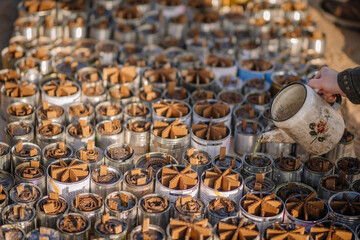 Trench candles on the table poured with wax, made by Ukrainian volunteers for soldiers serving on the front line.