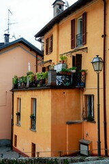 Fototapeta na wymiar Vertical shot of a simple building decorated with plants in Argegno, Italy