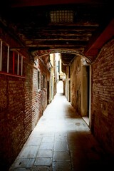 Vertical shot of a typical Venetian arched passage, Italy