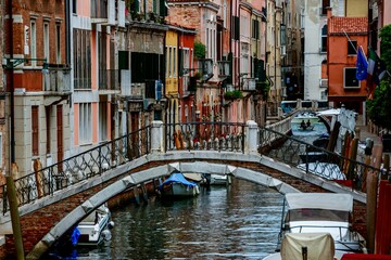 Fototapeta na wymiar Beautiful shot of a bridge across the canal and historic buildings in Venice, Italy