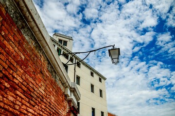 Low angle shot of historic buildings under a bright sky in Venice, Italy