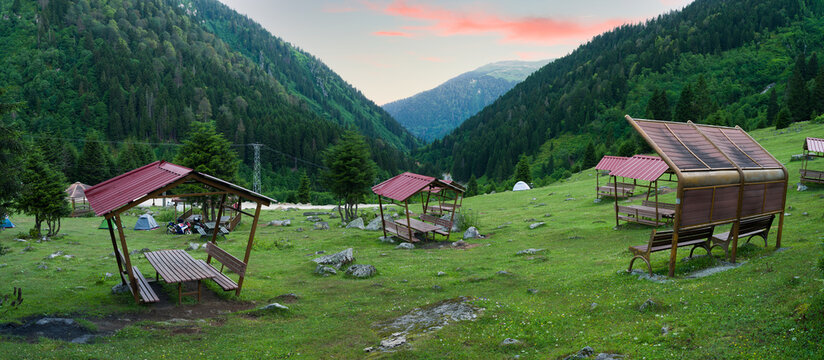 Picnic tables in beautiful mountain scenery. Ayder plateau picnic and camping area. Camlihemsin, Rize, Turkey