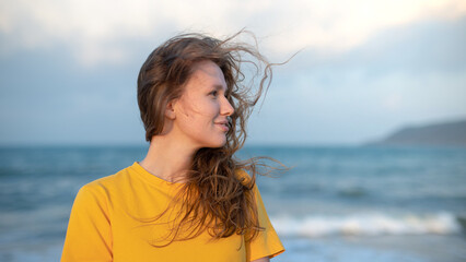 Obraz premium Portrait of happy girl, young carefree woman enjoying summer vacation on sea, walking on beach sand, smiling and having fun in tropical country, relaxing on nature. Summertime, happiness concept.