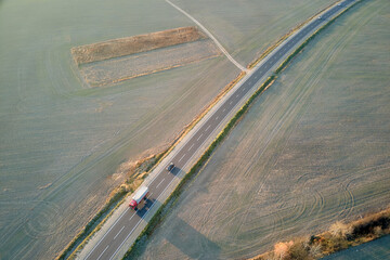 Aerial view of cargo truck driving on highway hauling goods. Delivery transportation and logistics...
