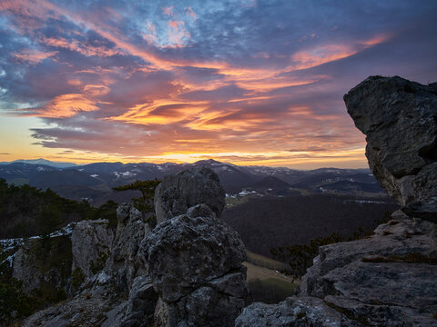 sunset in the mountains with rocks and impressive clouds