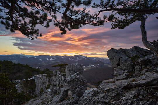 sunset in the mountains with rocks and impressive clouds