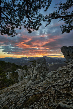 sunset in the mountains with rocks and impressive clouds