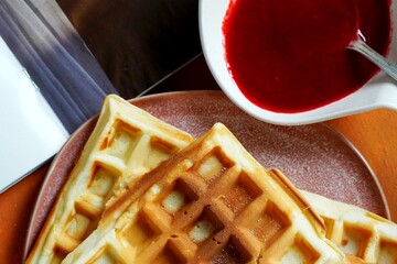 Waffles served with raspberry sauce