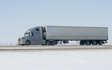 Heavy Cargo on the Road. A truck hauling freight along a highway. Taken in Alberta, Canada