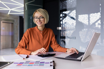 Portrait of successful financier woman, businesswoman behind paper accounting work smiling and...