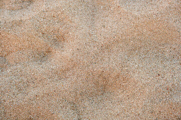 Flat view of clean yellow sand surface covering seaside beach. Sandy texture